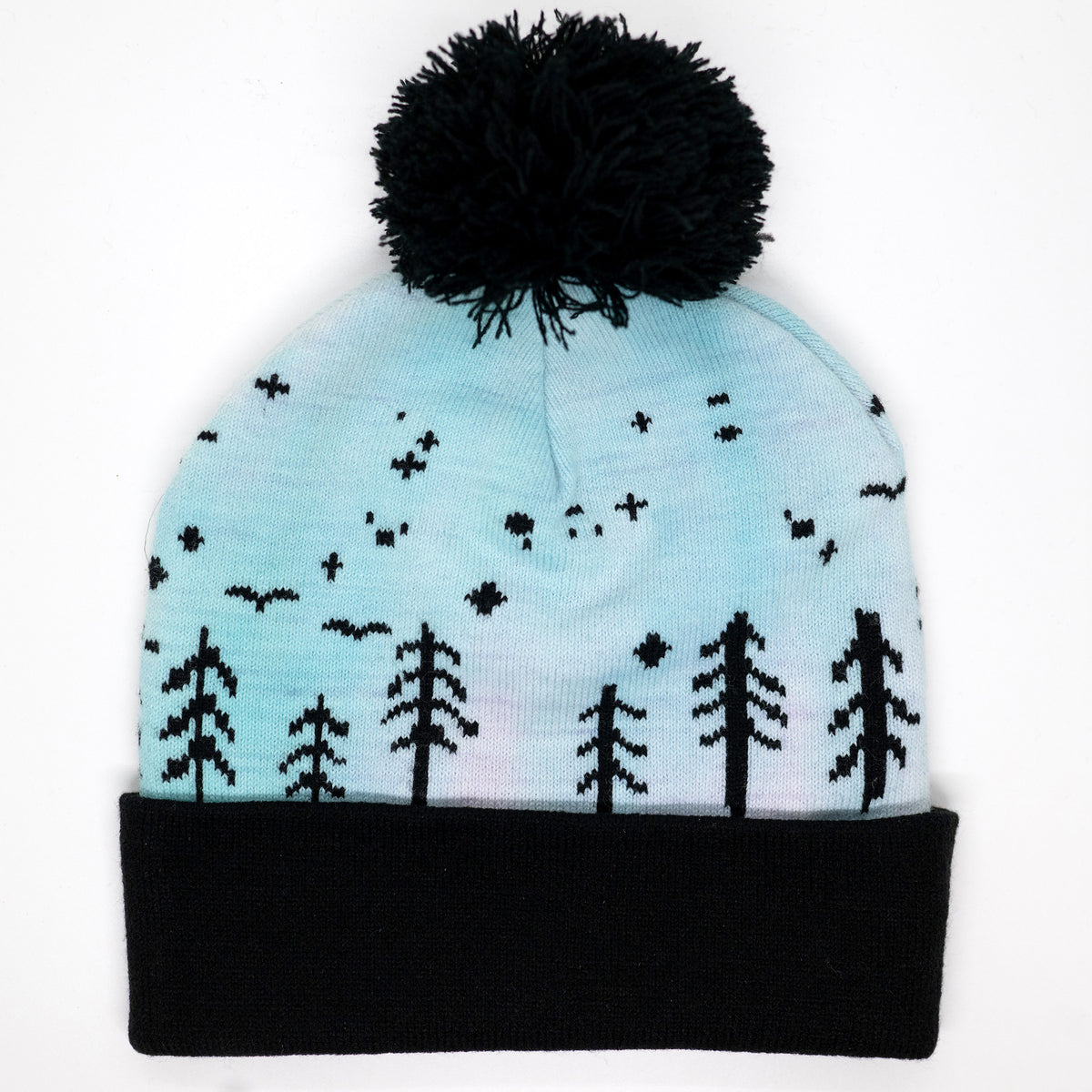Hand-dyed kids winter beanie fading from lavender to light blue with black pom-pom and forest design.
