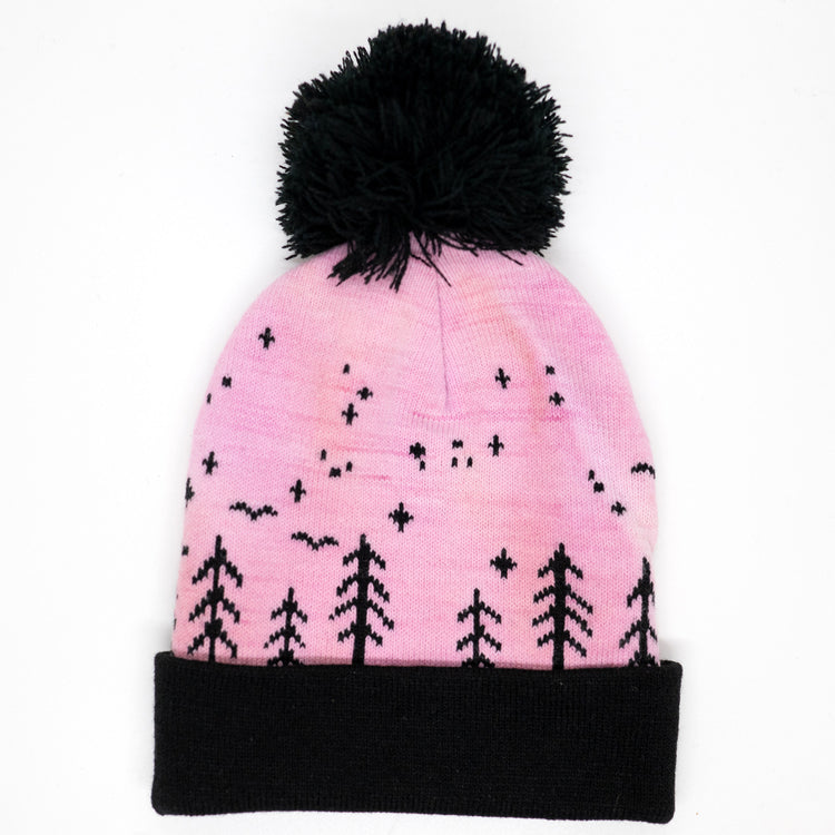 Pink hand-dyed kids winter beanie with black pom-pom, folded cuff, pine trees, moon and stars.