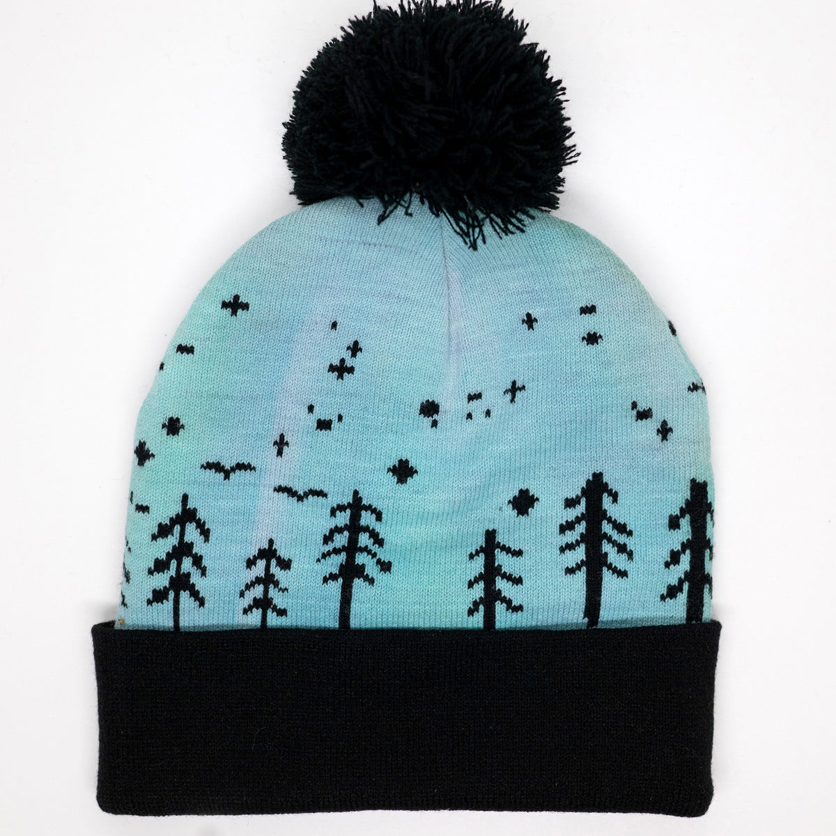 Hand-dyed kids winter beanie fading from lavender to light blue with black pom-pom and forest design.
