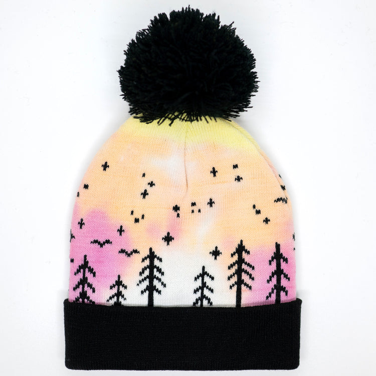 Hand-dyed pink and yellow kids winter beanie with black pom-pom, folded cuff, pine trees, moon and stars.