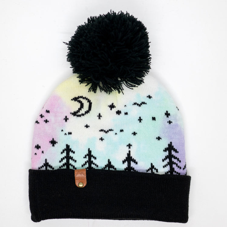 Hand-dyed pink, yellow, blue and purple kids winter beanie with black pom-pom, folded cuff, pine trees, moon and stars.