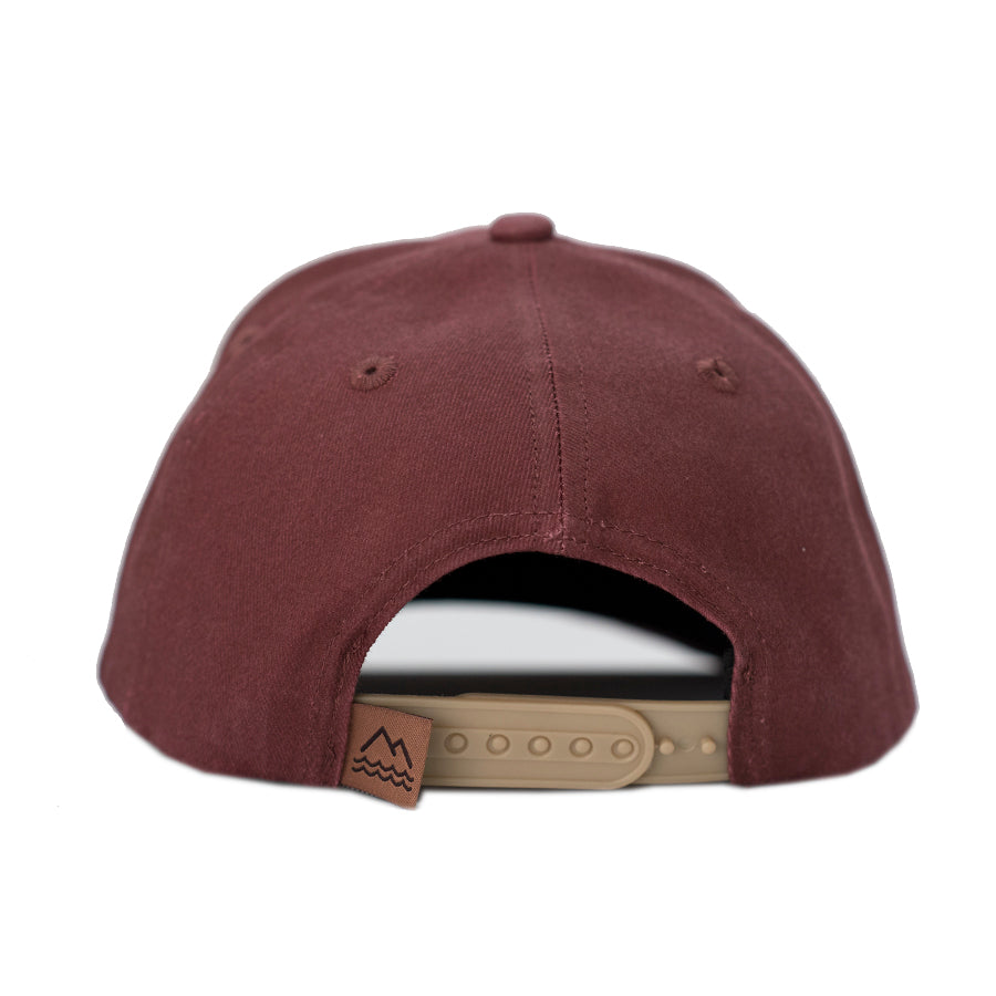 Deep red vintage washed cotton kid's hat with a hexagon shaped leather patch. This hat will only get cooler with age as the vintage looking fabric fades in all the right places. Stylish in any season, our kid's hats are built to last and will fit your kids for years.