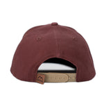 Load image into Gallery viewer, Deep red vintage washed cotton kid&#39;s hat with a hexagon shaped leather patch. This hat will only get cooler with age as the vintage looking fabric fades in all the right places. Stylish in any season, our kid&#39;s hats are built to last and will fit your kids for years.
