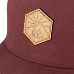 Load image into Gallery viewer, Deep red vintage washed cotton kid&#39;s hat with a hexagon shaped leather patch. This hat will only get cooler with age as the vintage looking fabric fades in all the right places. Stylish in any season, our kid&#39;s hats are built to last and will fit your kids for years. 
